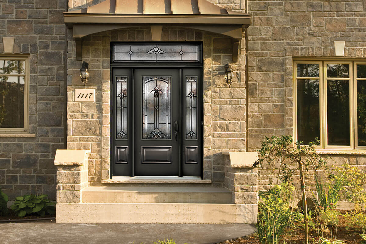 Front door with a sidelite, transom and decorative glass insert.