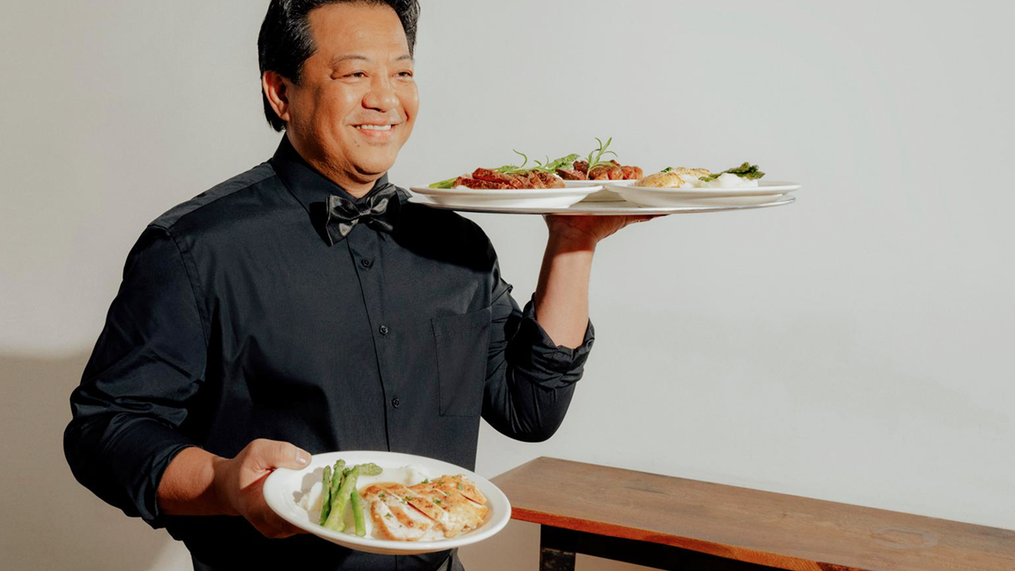 Catering staff carrying dishes.