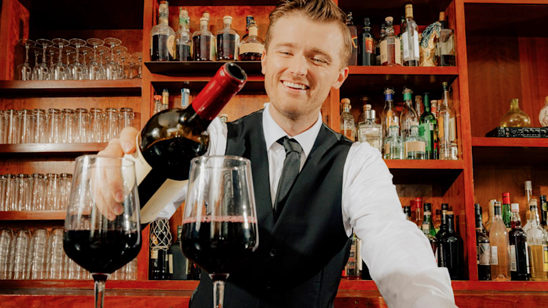 Hotel staff serving at bar