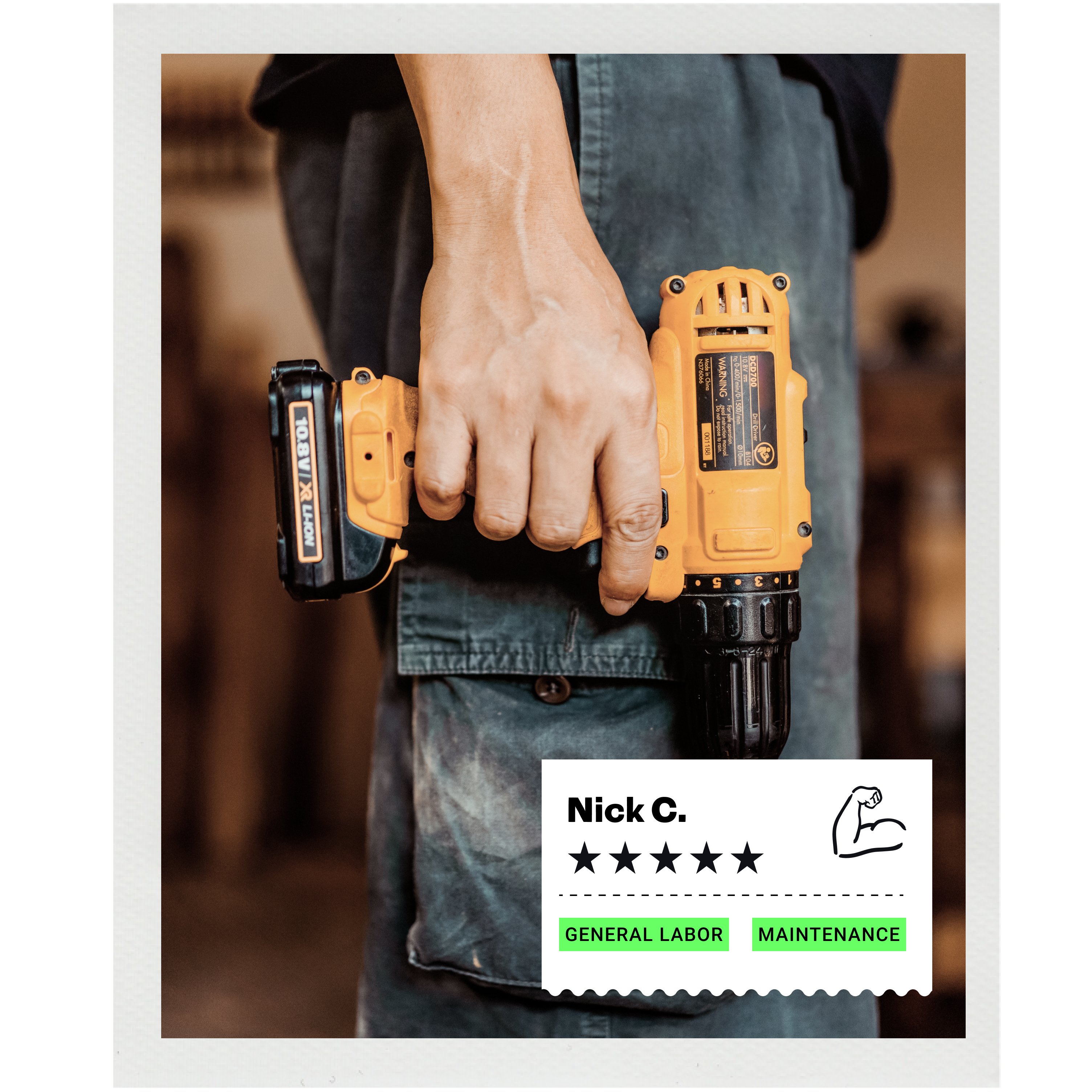 Person holding electric drill in their hand.