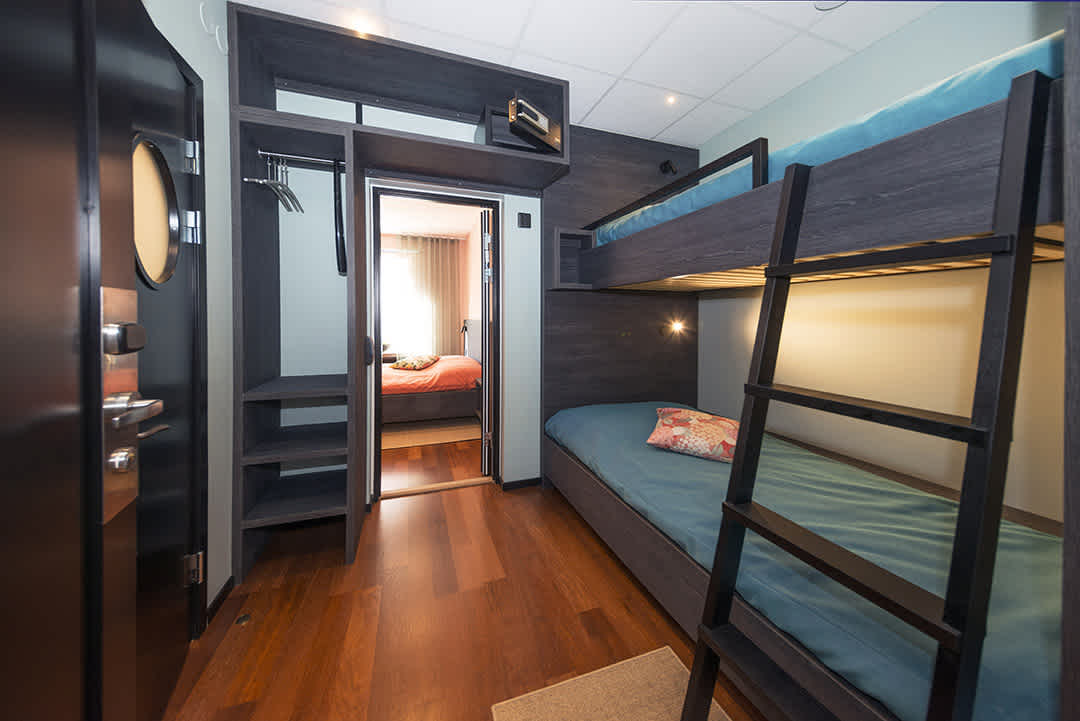 Room Carma at Staykvick Boutique Hostel. Turquoise interior details and a nice bunk bed