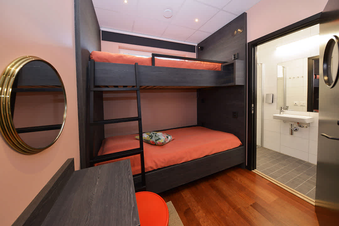 Room Ida at Staykvick Boutique Hostel. Coral details and a nice bunk bed for two.