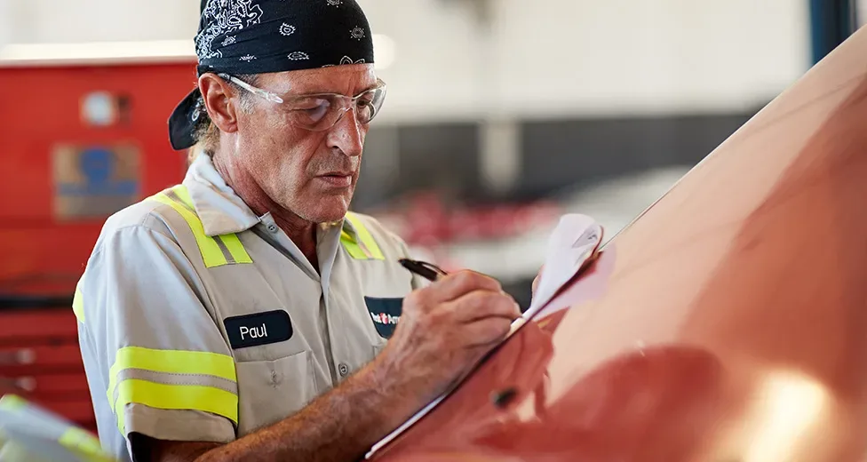 worker doing an inspection to a truck