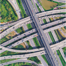 Aerial view of a complex highway interchange with multiple levels of roads, bridges, and ramps crossing each other.