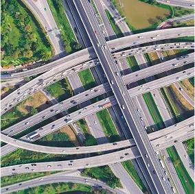 Aerial view of a complex highway interchange with multiple levels of roads, bridges, and ramps crossing each other.