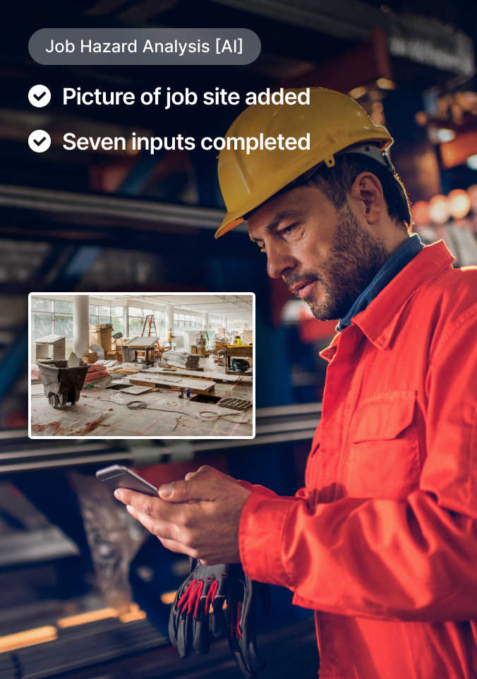 Construction worker in yellow helmet and orange jacket using smartphone with job hazard analysis interface displayed.