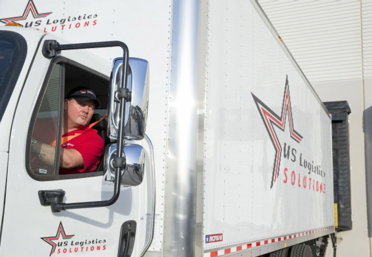 Photo of US Logistics Solutions driver looking out the window of a truck