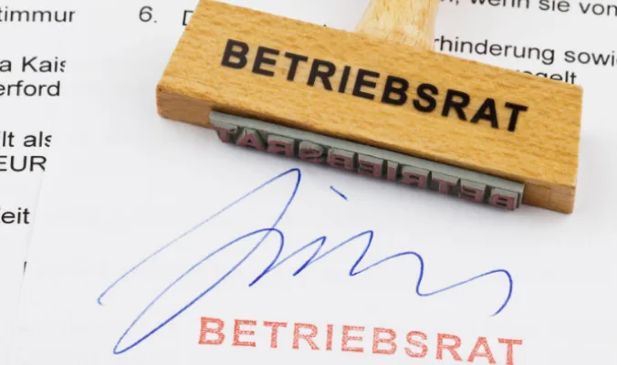 A stamp that says Works Council with someone’s signature on a document.