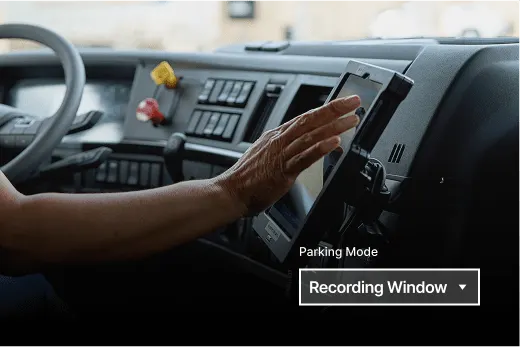 Hand adjusting a dashboard device in a truck cab showing "Parking Mode" and "Recording Window" interface options.