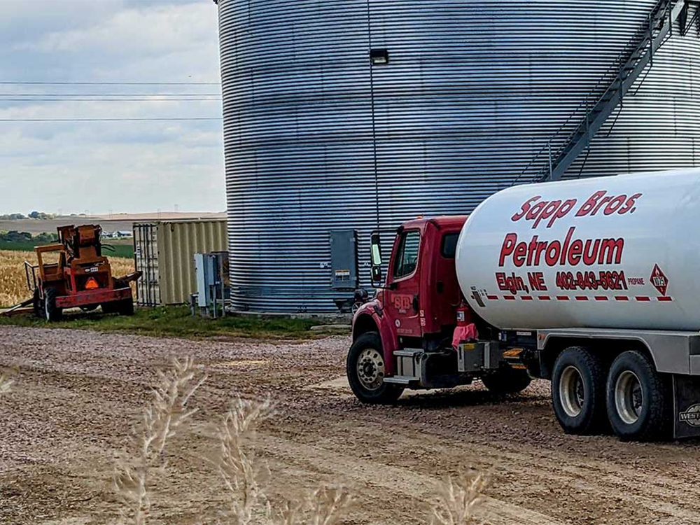 Sapp Bros. tanker next to silo in field