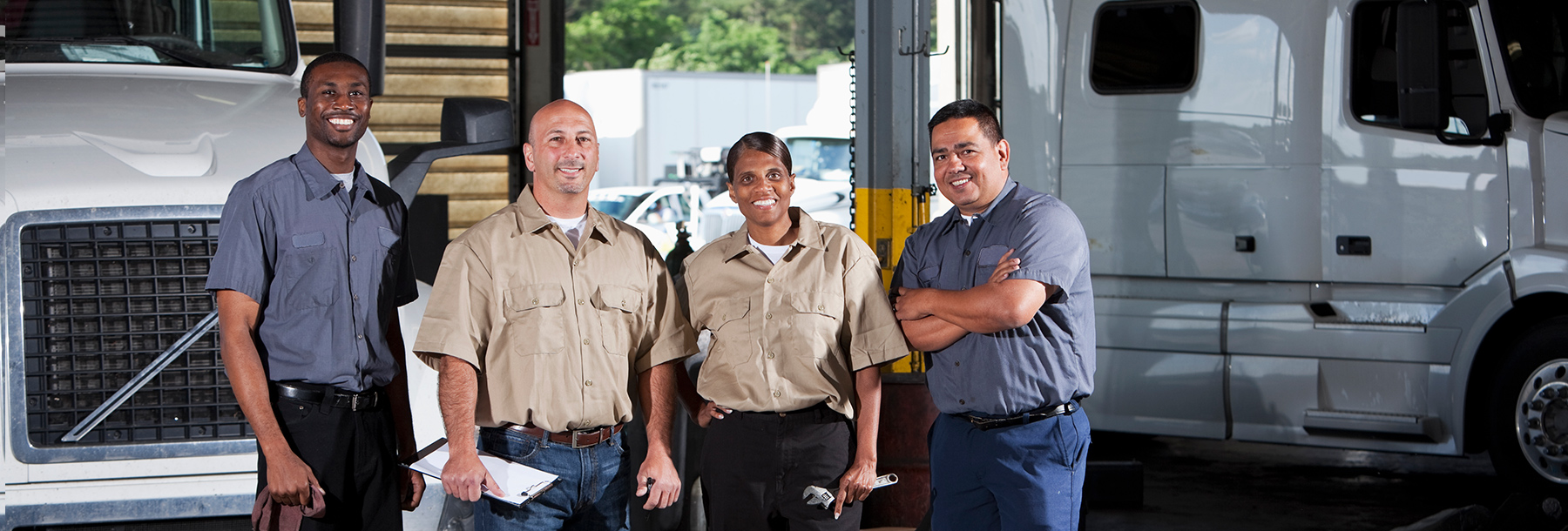 Workers in service garage at trucking company