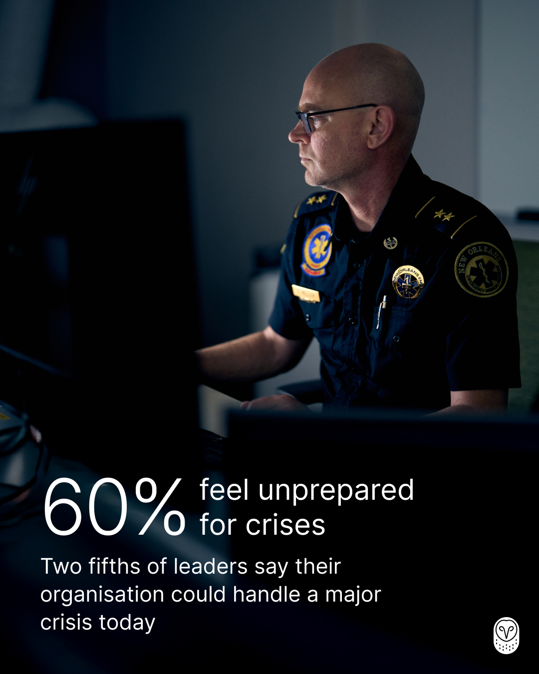Security officer in uniform working at computer in dark room with statistic: 76% feel unprepared for crises.