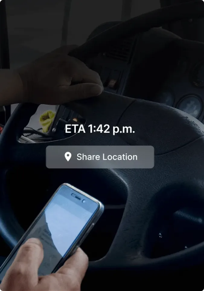 Person checking smartphone while driving, with navigation screen showing ETA 1:42 p.m. and Share Location button.