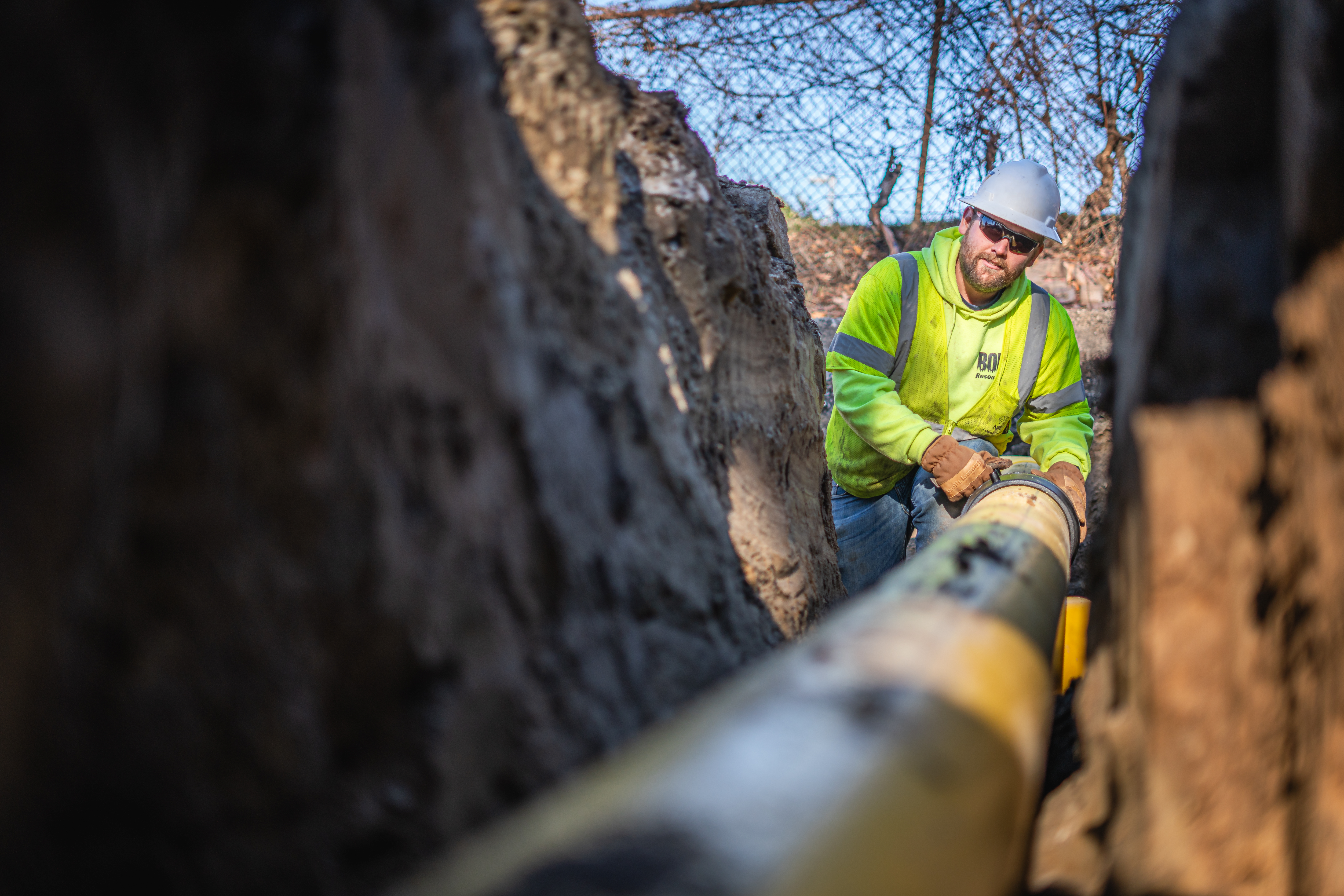 Hope Gas worker fixing large pipeline