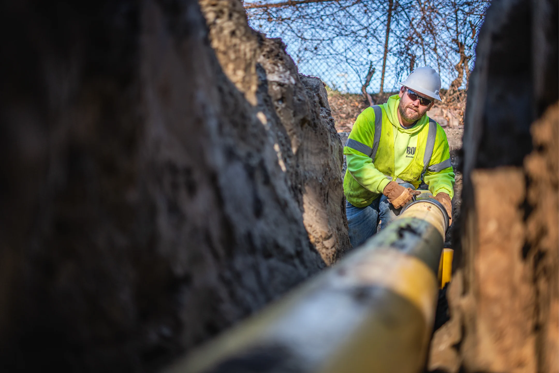 Hope Gas worker fixing large pipeline