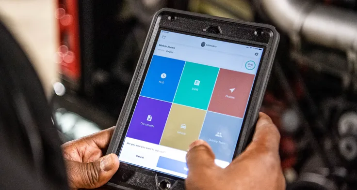 Person holding Tablet with Samsara dashboard visible in hands. 