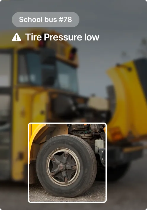Yellow school bus #78 with warning alert showing low tire pressure, featuring close-up of a deflated tire.