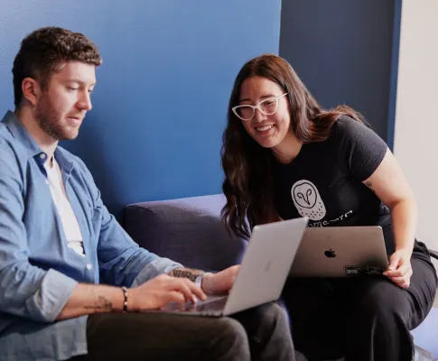 Developer’s looking at a laptop and discussing something.