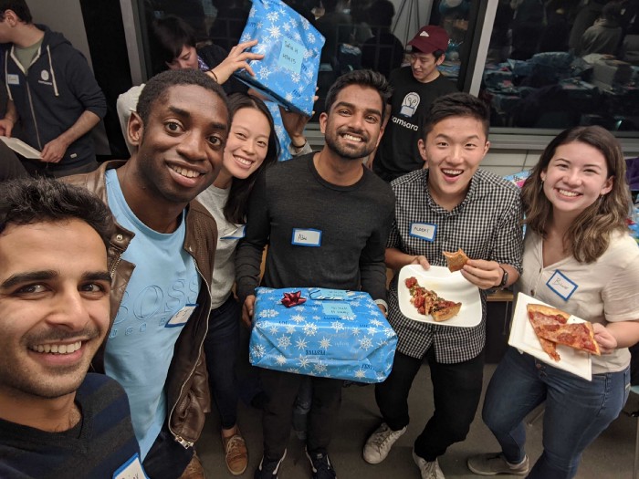 The Compliance team showing off our wrapped presents at Deck the H’owls.