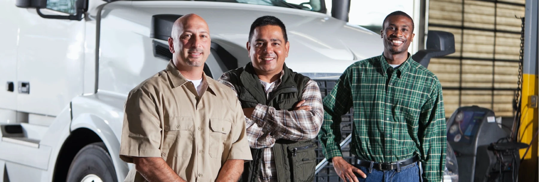 Happy drivers in front of white semi-truck