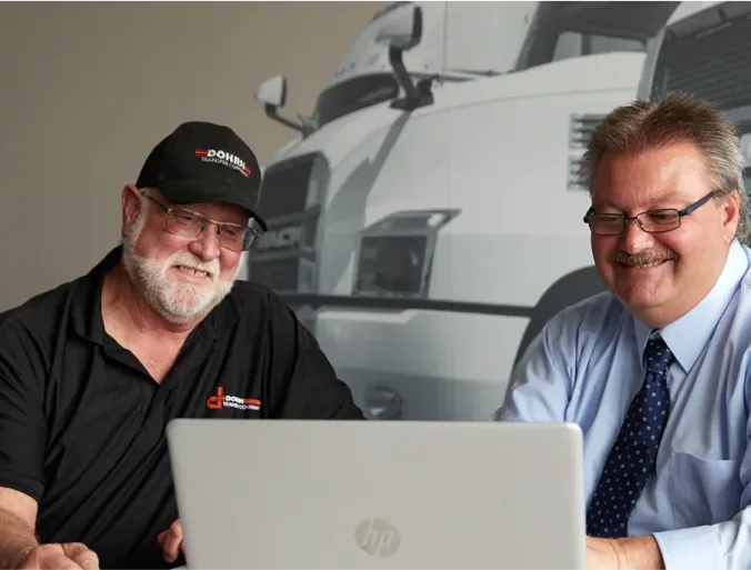 two workers looking at a screen
