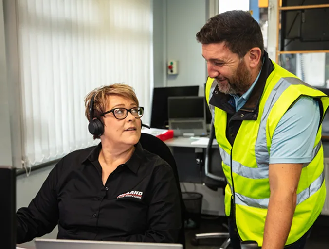 two workers looking at a screen