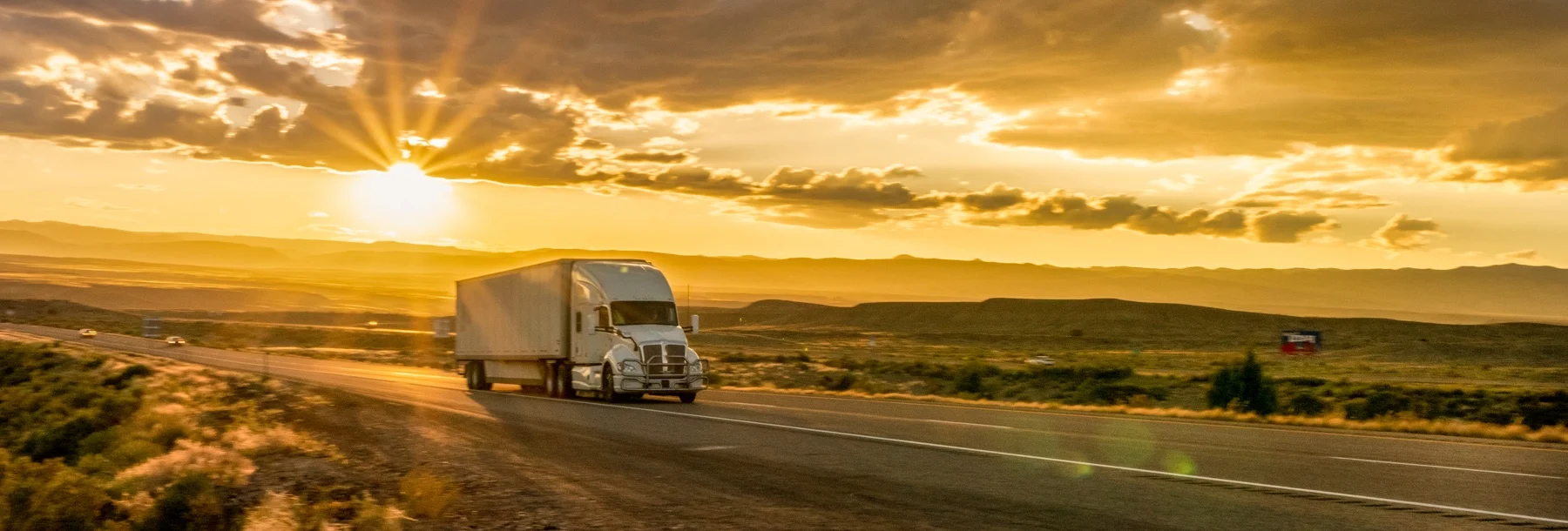 Semi-Truck on an Interstate Highway at Dusk with Clouds