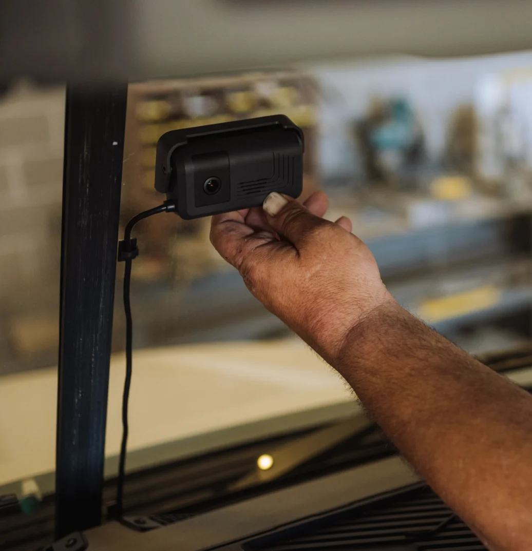 Hand adjusting a Samsara AI Dash Cam