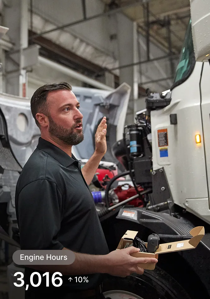 person inspecting an enginee