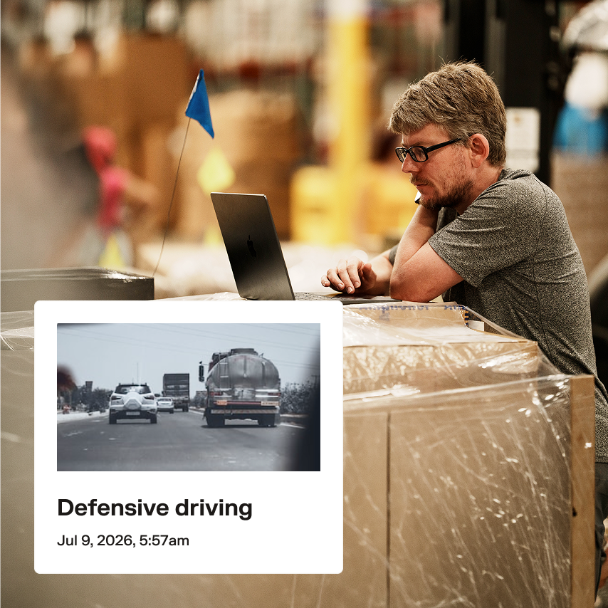 Man using laptop in warehouse, with a defensive driving course card showing a truck on a road dated Jul 9, 2026.