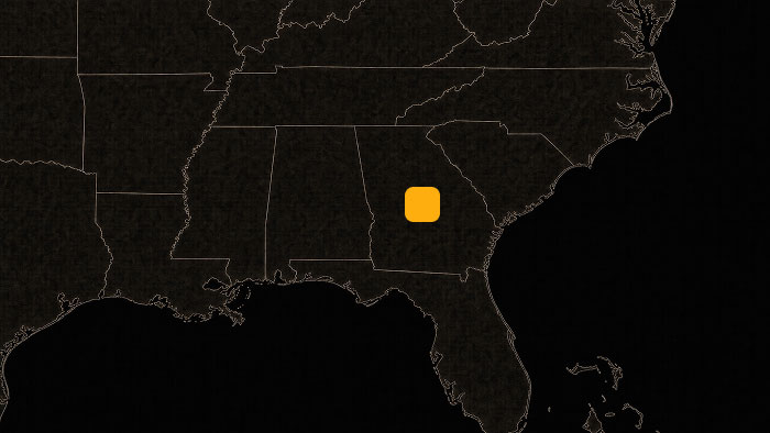Dark map of the southeastern United States with an orange marker highlighting a location in central Georgia.
