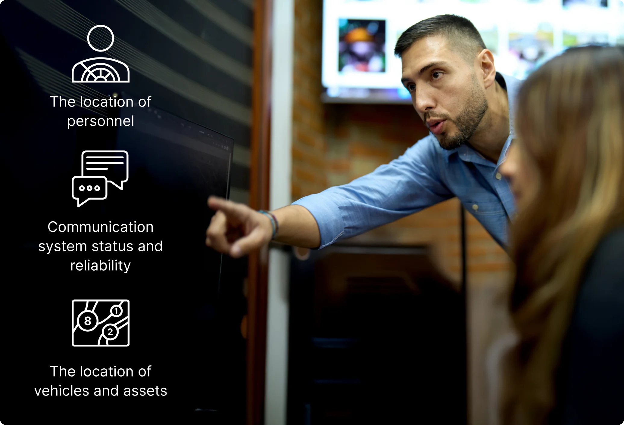 Person pointing at screen displaying tracking system icons for personnel, communication status and vehicle locations.