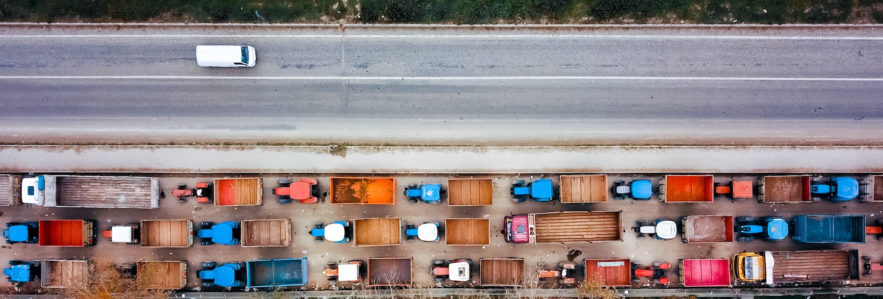 Trucks on a road in the fall.