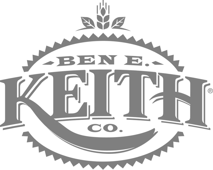 Gray circular badge logo for Ben E. Keith Co. with serrated edges and a wheat stalk emblem on top.