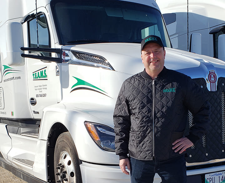 TEAMS worker beside a truck