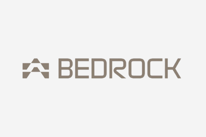 Bedrock logo in taupe color featuring a stylized mountain or triangular icon next to the company name.