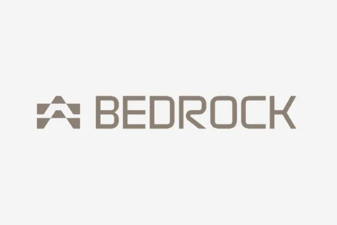 Bedrock logo in taupe color featuring a stylized mountain or triangular icon next to the company name.