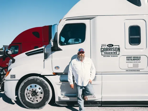 Man standing by RE Garrison truck.