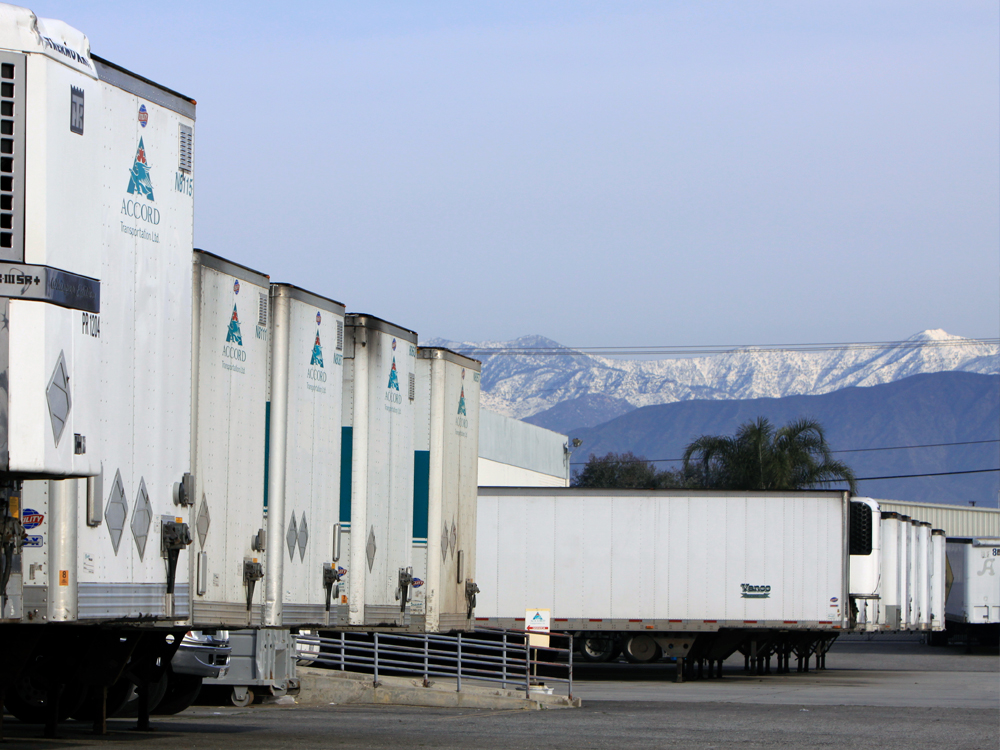 Accord Transportation trailers in a yard with mountains in the background