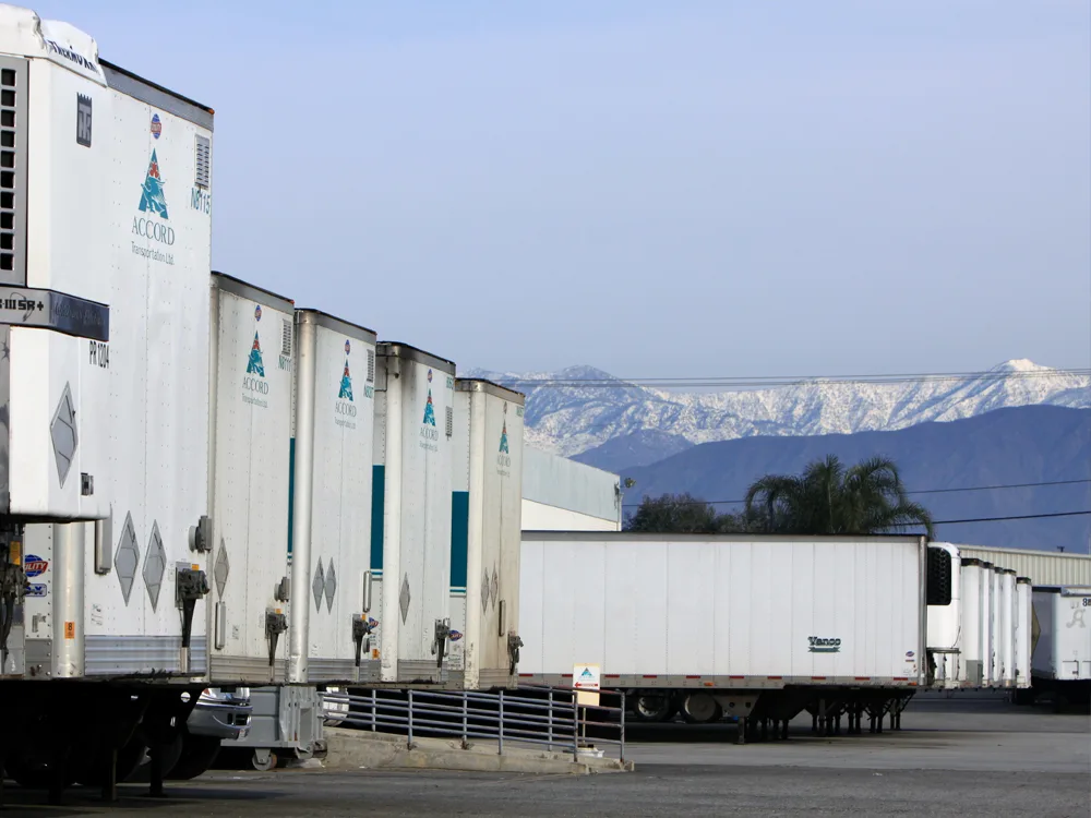 Accord Transportation trailers in a yard with mountains in the background