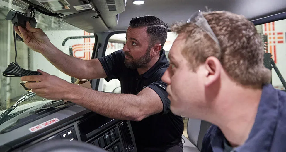 Person installing a dashcam in a truck