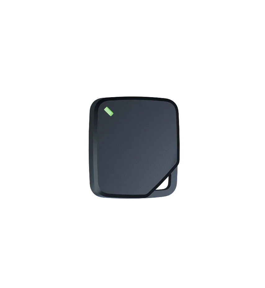 Dark gray square device with rounded corners, featuring a small green indicator light in the upper left corner.