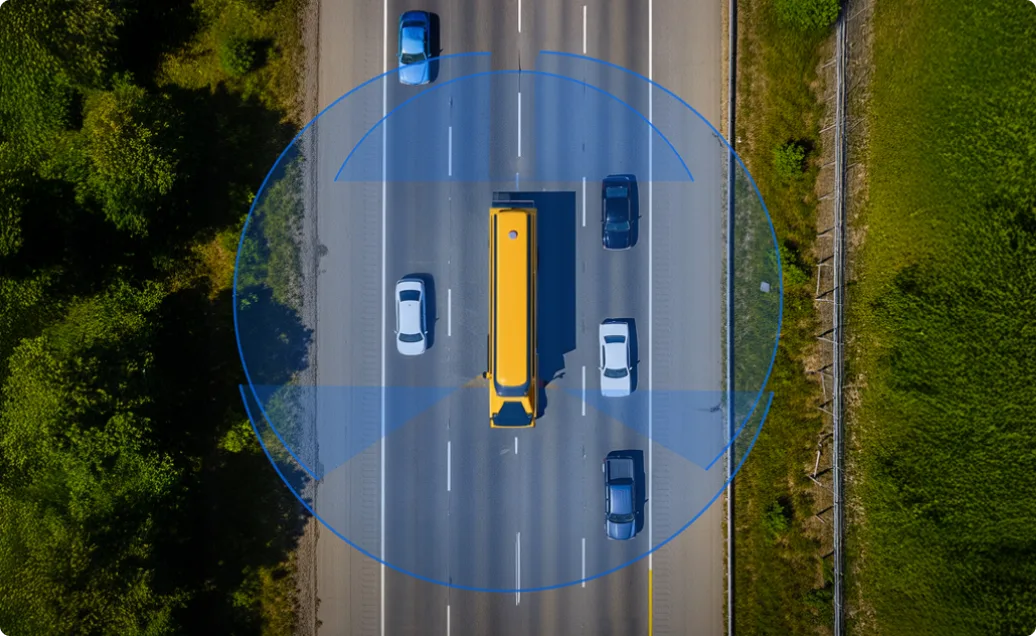Aerial view of highway with yellow bus and cars, surrounded by blue circular sensor or detection zone.