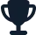 A dark silhouette of a trophy or award cup against a plain background, representing achievement or victory.
