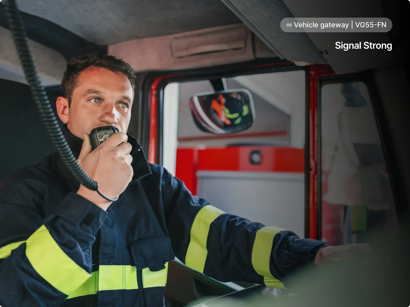 Driver in emergency vehicle with navigation interface showing vehicle gateway connection status.