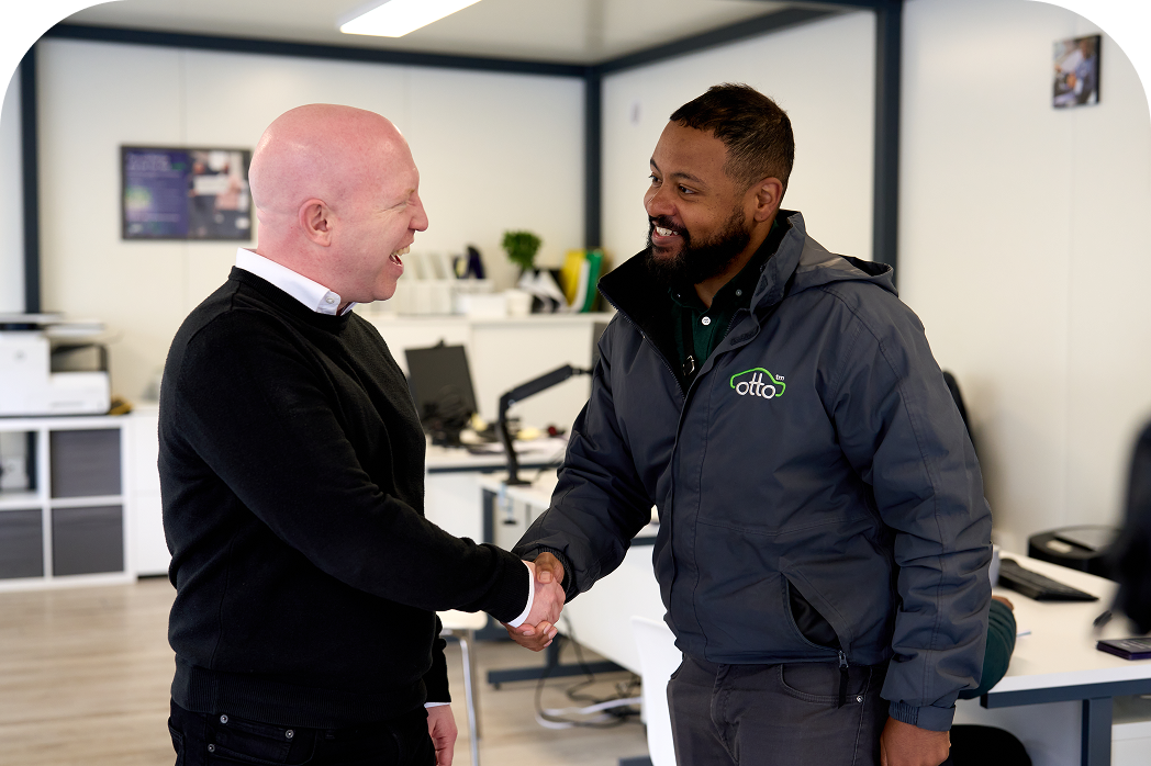 Two sets of people standing next to each other smiling