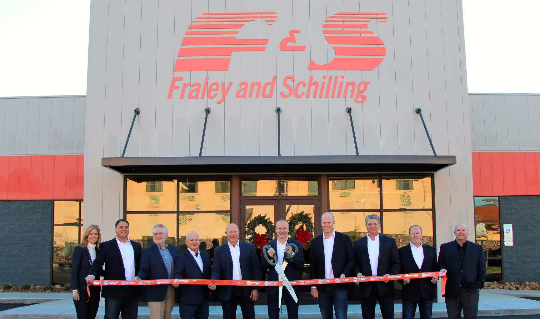 Ribbon cutting ceremony outside of a Fraley & Schilling office building