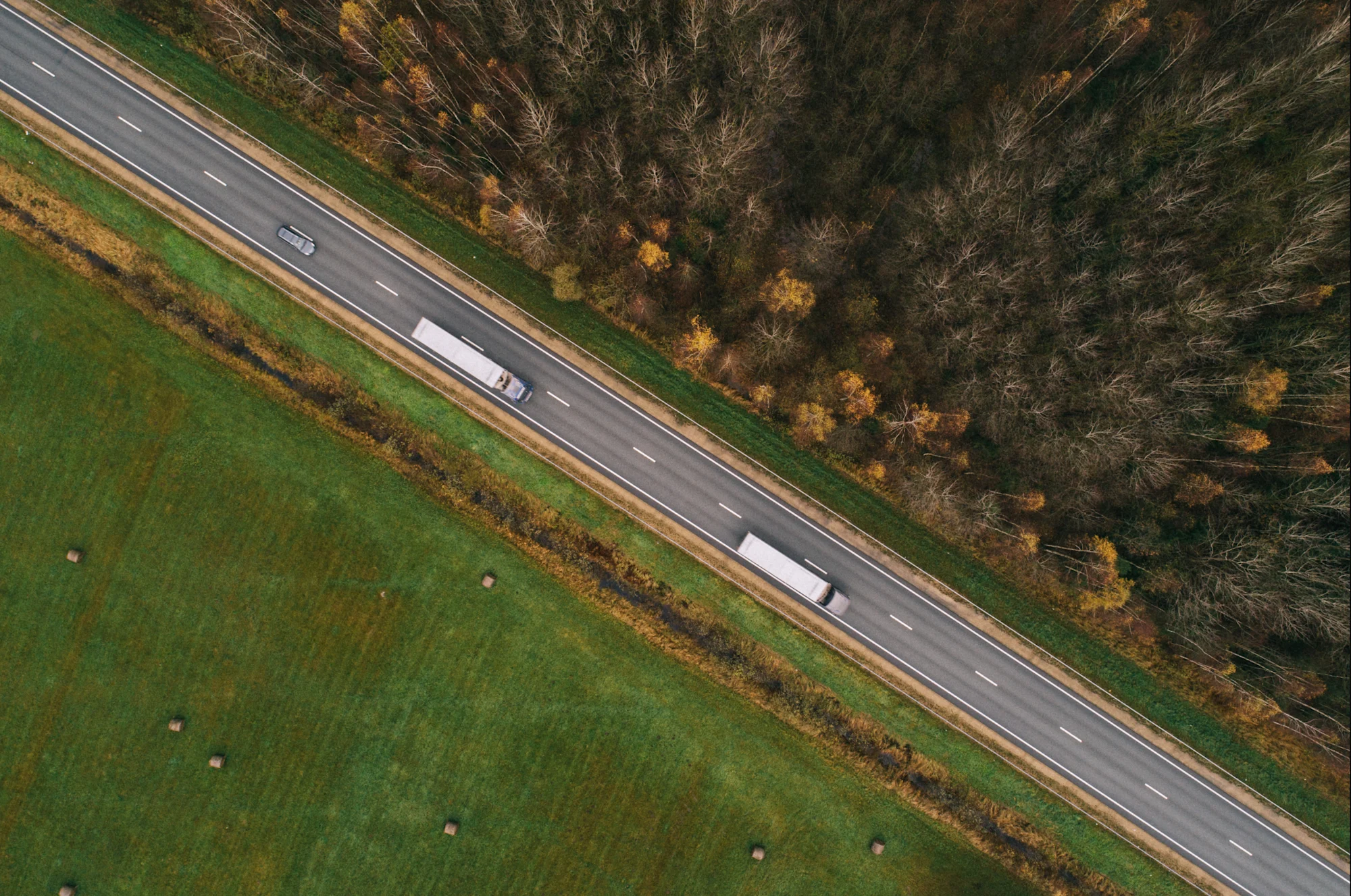 Truck traveling on green highway