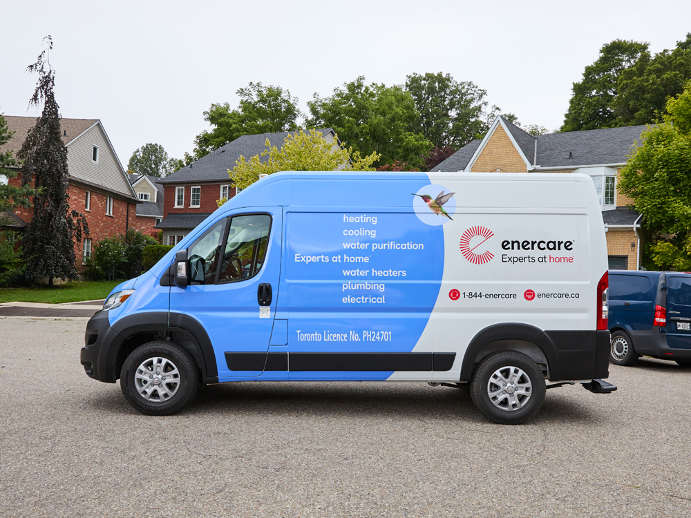Blue and white Enercare van parked on a residential street