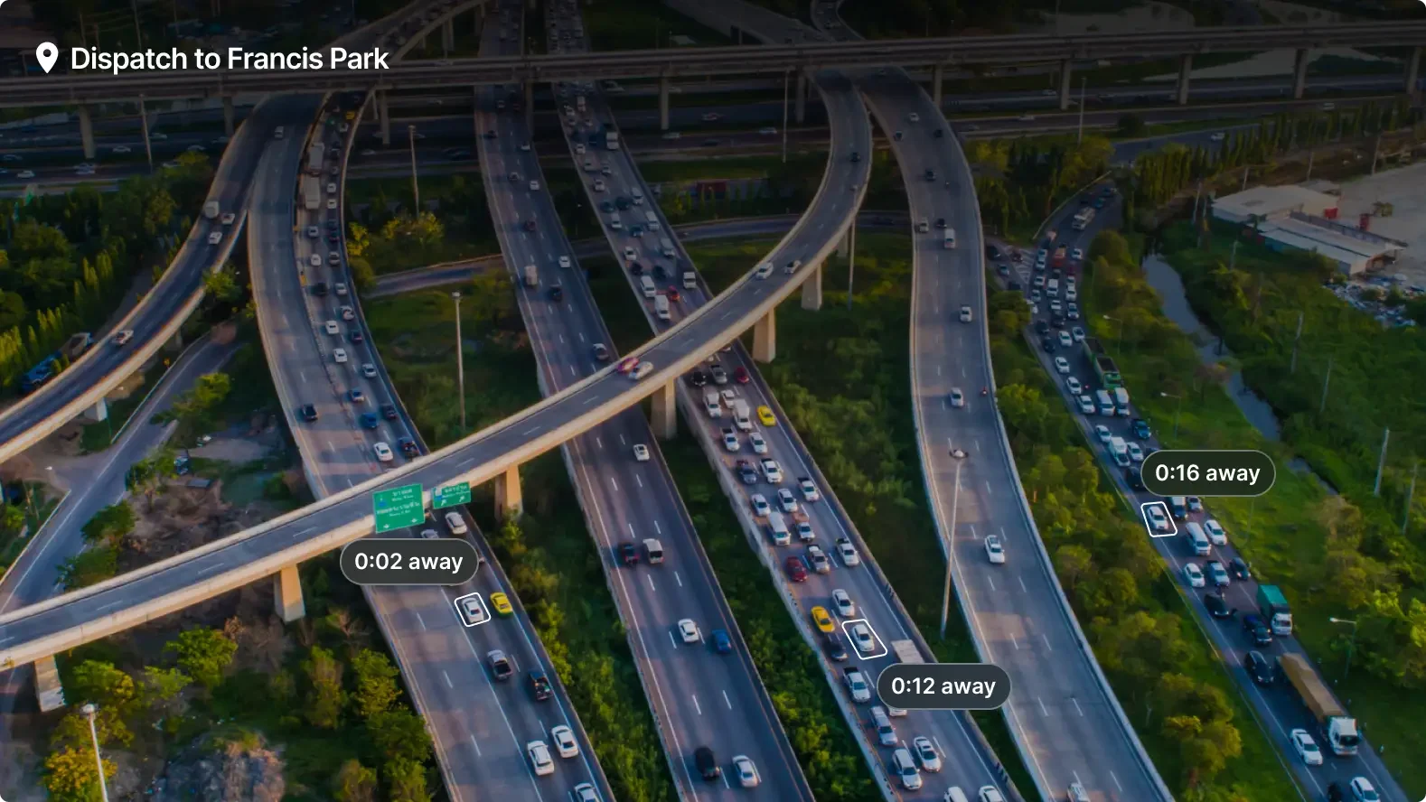Aerial view of complex highway interchange near Francis Park with traffic and navigation indicators showing travel times.